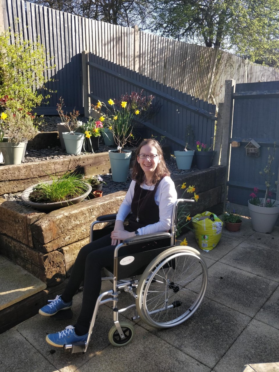 Angela Wright in her wheelchair in a garden